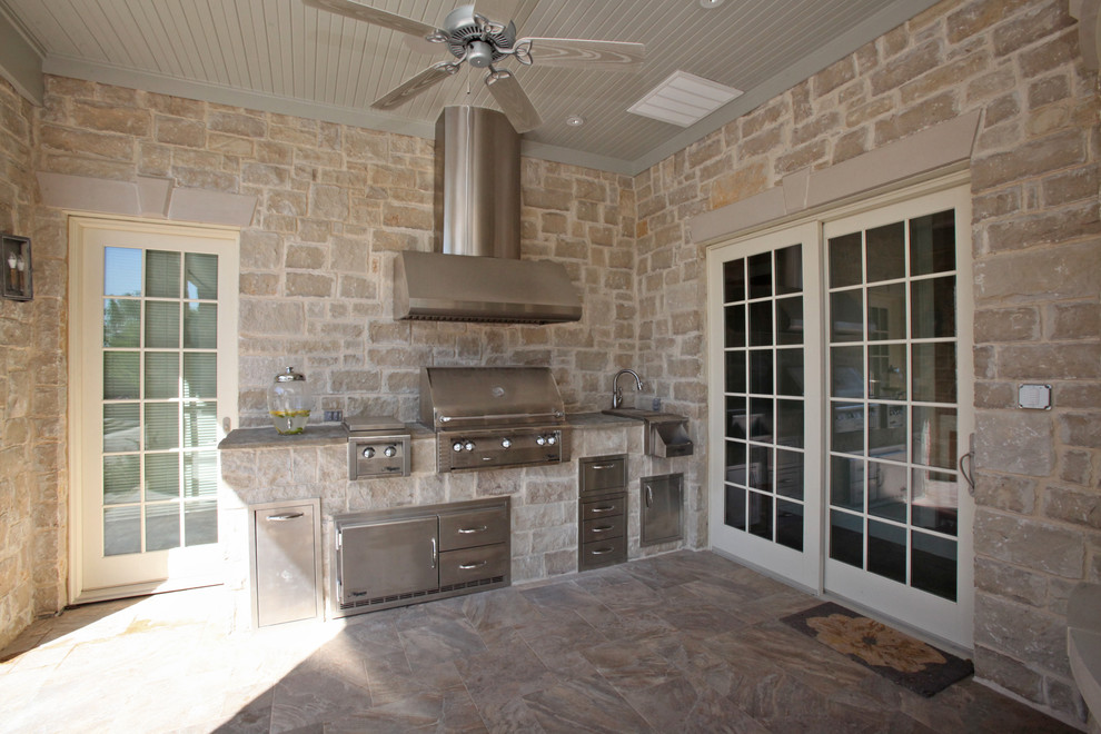 Example of a mid-sized classic backyard tile patio kitchen design in Dallas with a roof extension