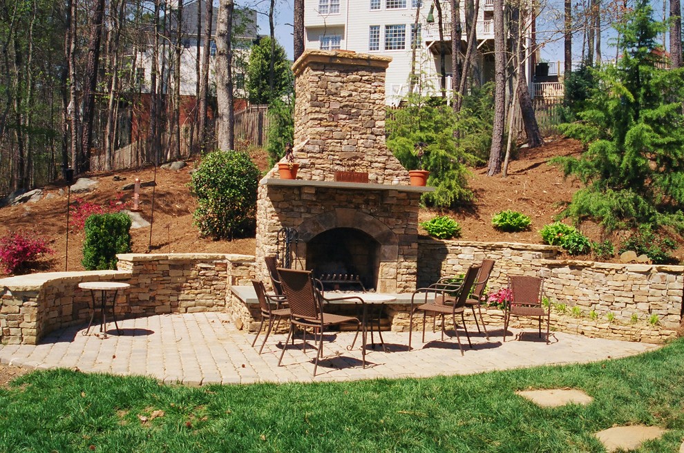Patio - large traditional backyard stone patio idea in Atlanta with a fire pit and no cover