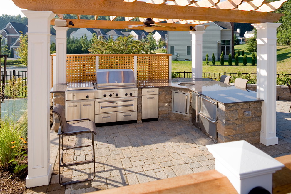 Inspiration for a medium sized classic back patio in DC Metro with an outdoor kitchen, natural stone paving and a gazebo.