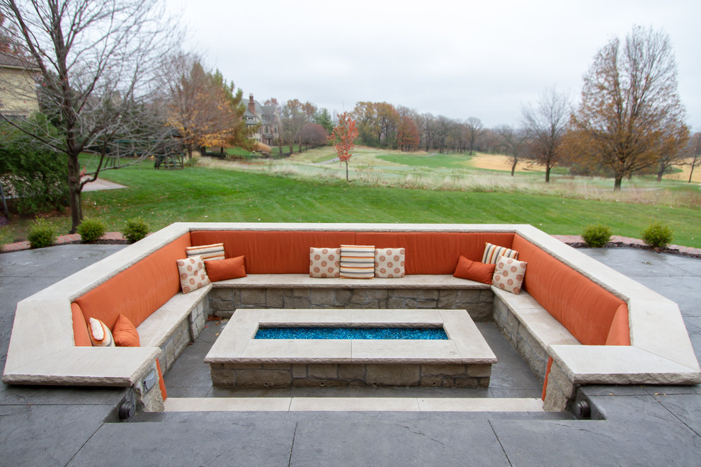 Inspiration for a large transitional backyard stamped concrete patio remodel in Kansas City with a fire pit and no cover