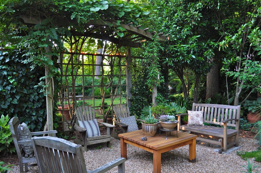 Example of a classic gravel patio design in Charlotte with no cover