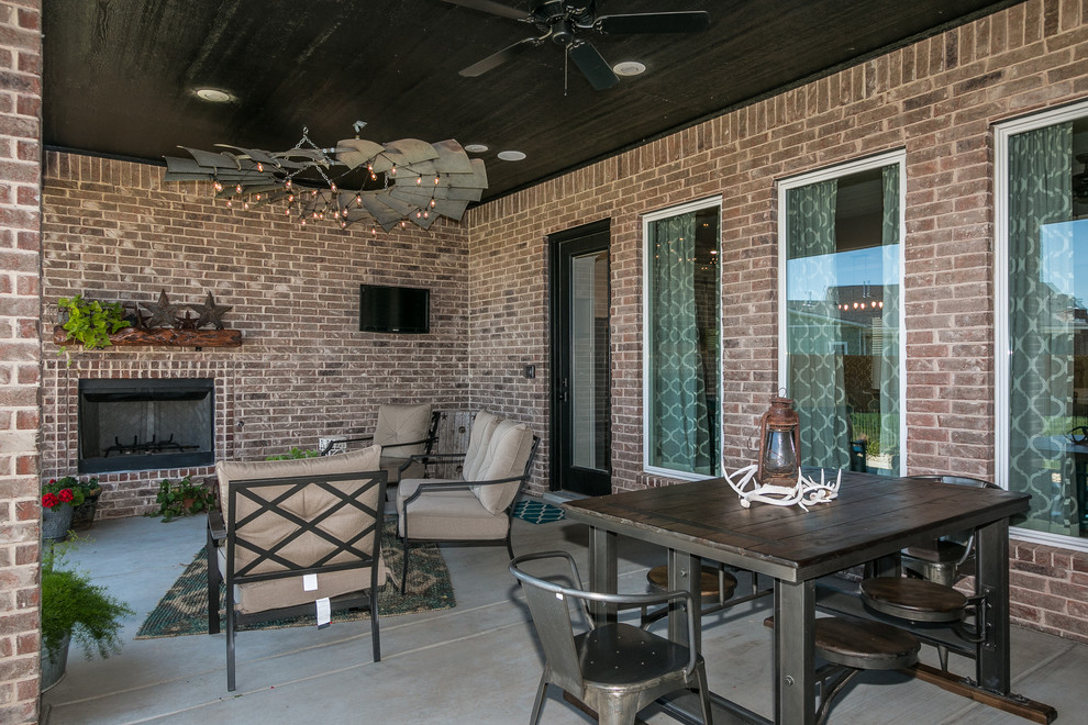 This is an example of a contemporary back patio in Dallas with concrete slabs and a roof extension.