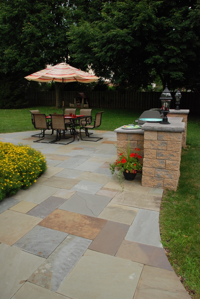 Inspiration for a small timeless backyard stone patio kitchen remodel in Philadelphia with no cover