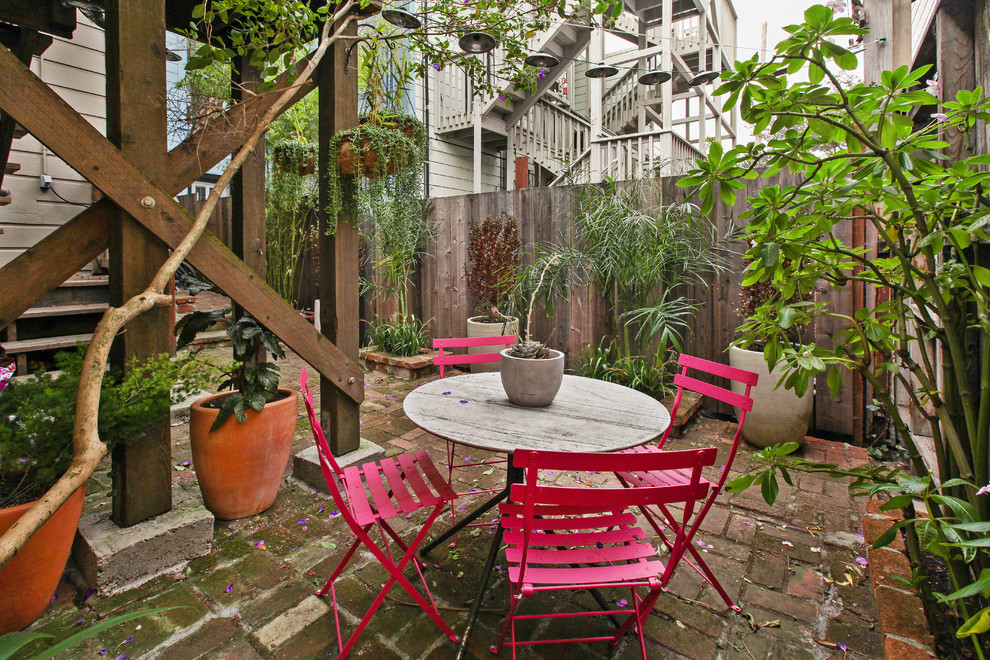 Foto di un piccolo patio o portico vittoriano dietro casa con pavimentazioni in mattoni