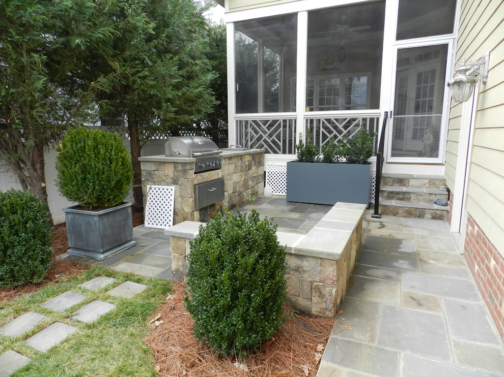 Idées déco pour une petite terrasse latérale classique avec une cuisine d'été, aucune couverture et des pavés en béton.
