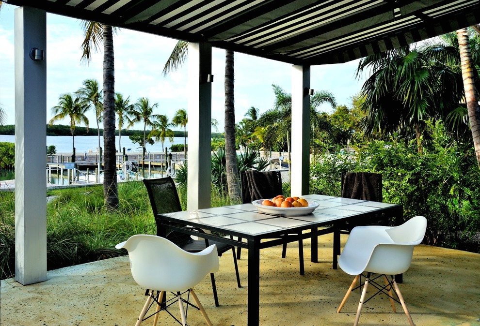 Contemporary patio in Miami with a pergola.