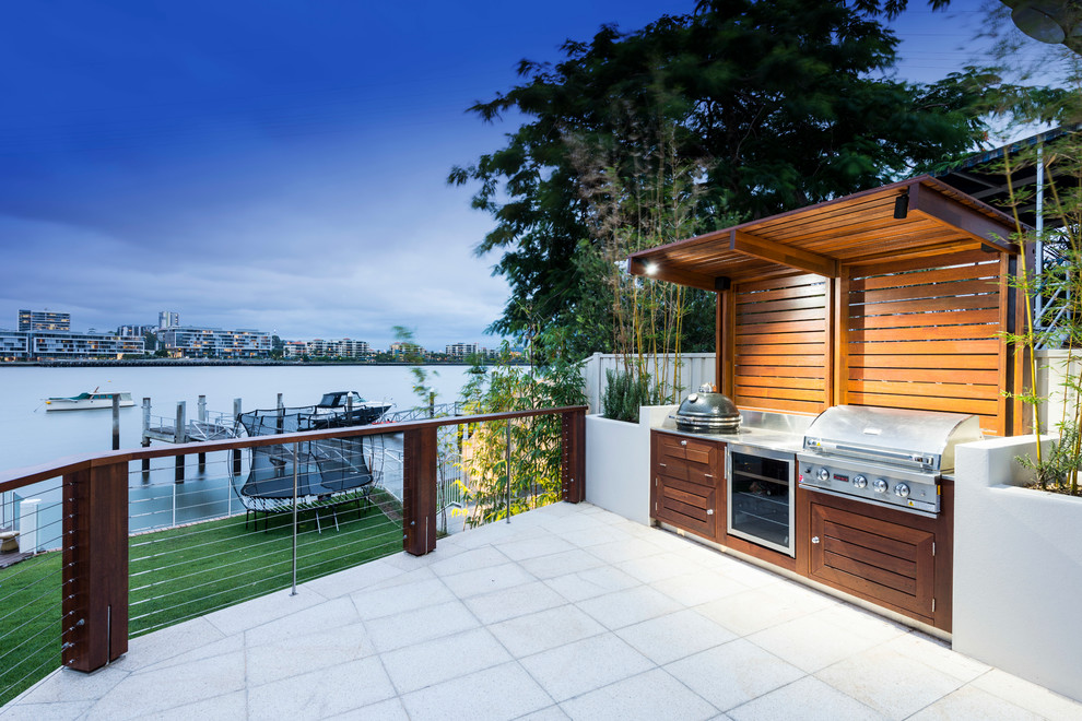 Example of a mid-sized trendy backyard concrete paver patio design in Brisbane with a pergola