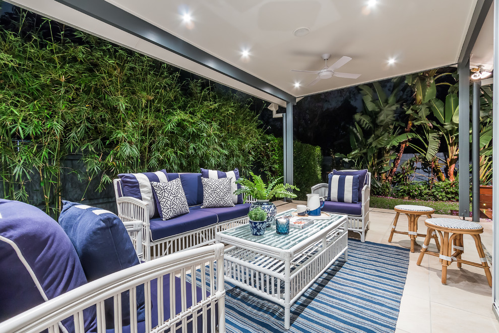 This is an example of a beach style patio in Brisbane with a roof extension.