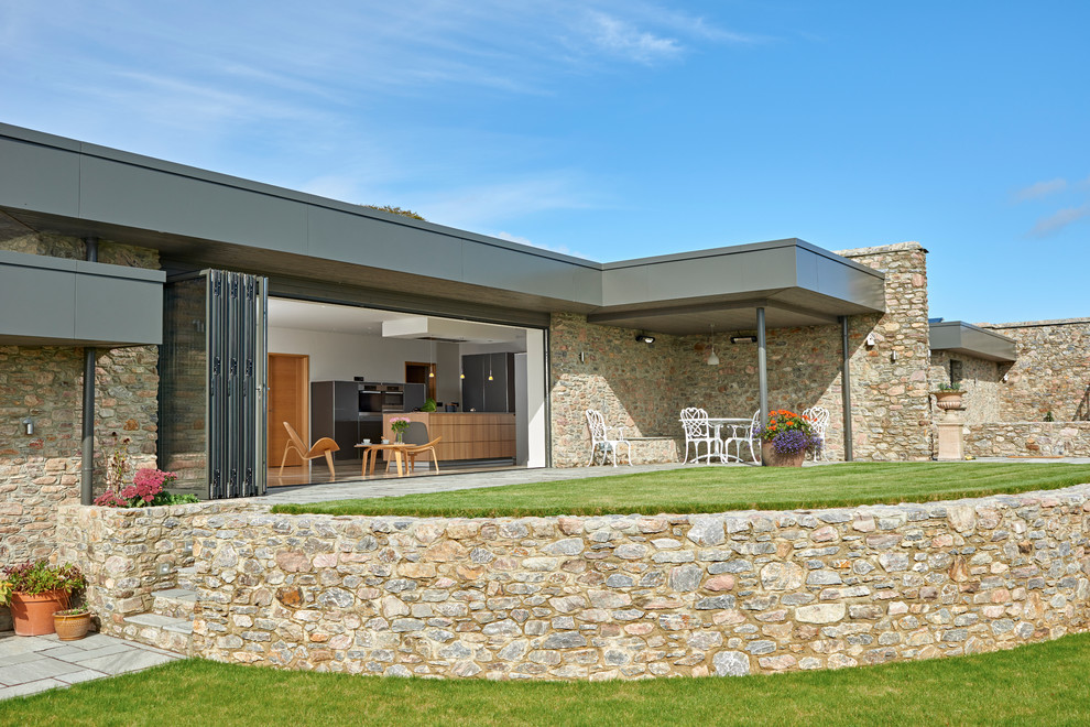 Photo of a large contemporary back patio in Devon with an outdoor kitchen and a roof extension.