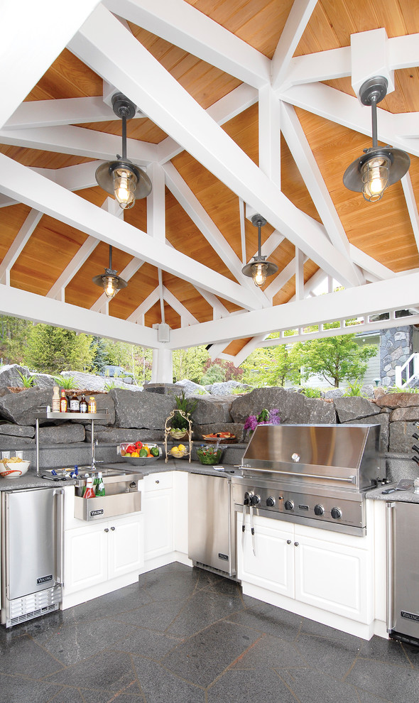 Patio kitchen - mid-sized traditional backyard stone patio kitchen idea in Other with a gazebo