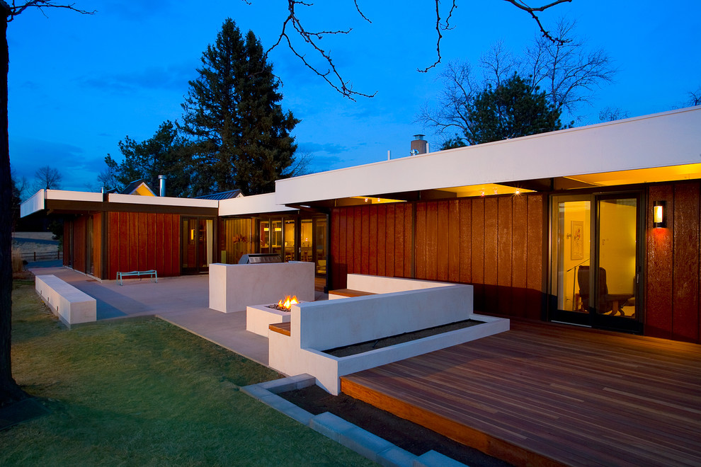 Aménagement d'une terrasse moderne avec un foyer extérieur.