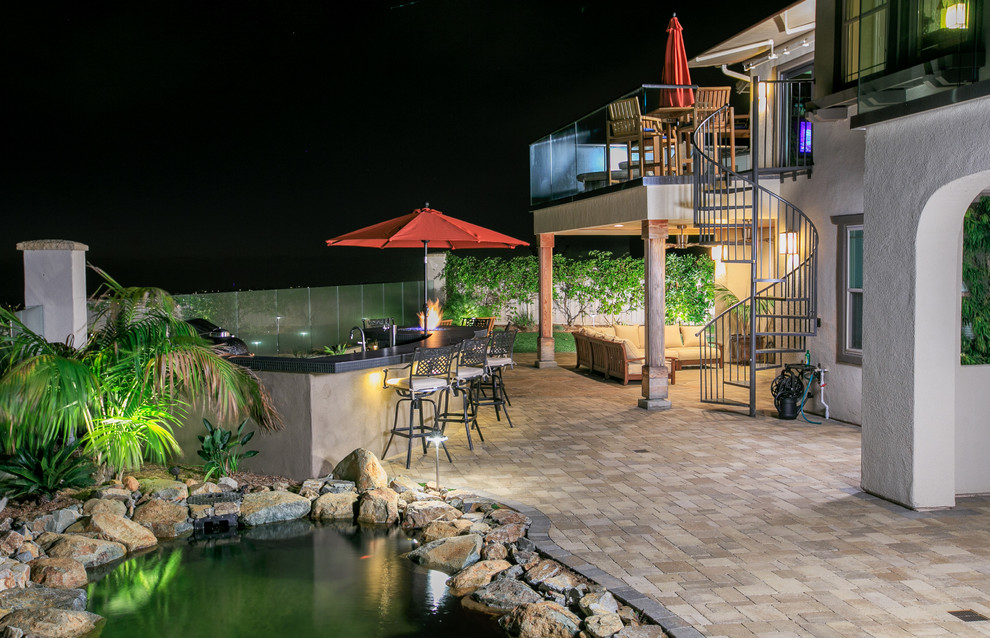 Inspiration for a mid-sized timeless backyard concrete paver patio remodel in San Diego with a fire pit