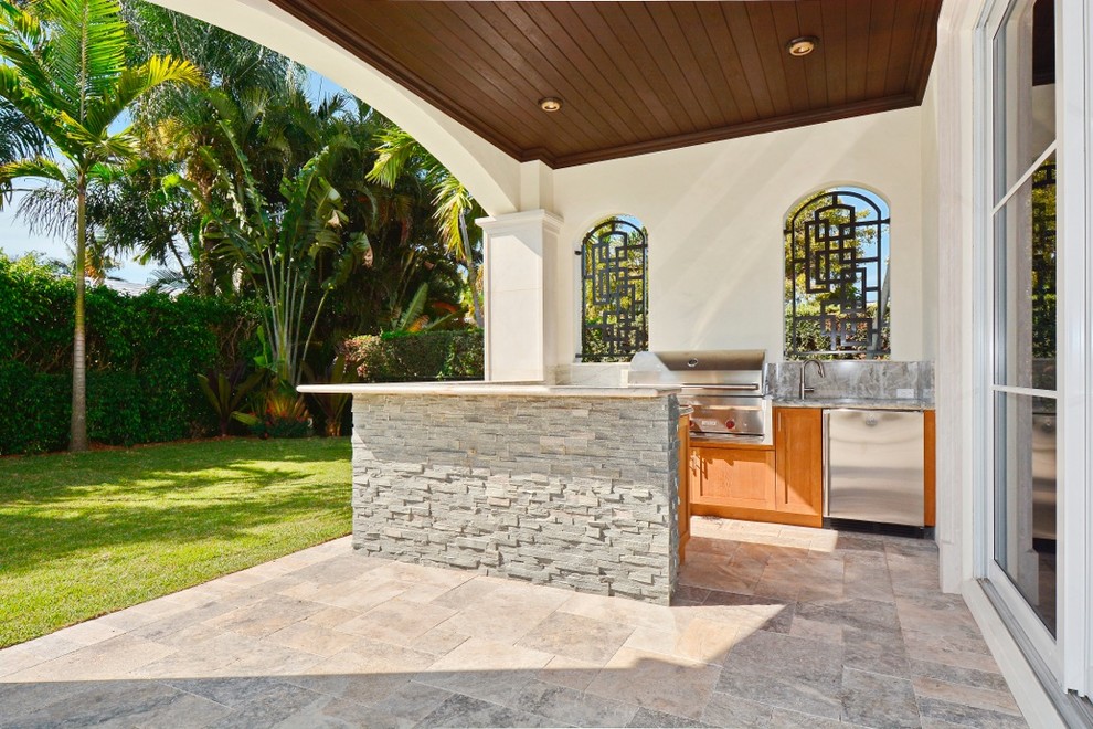 Mid-sized tuscan backyard stone patio kitchen photo in Miami with a roof extension