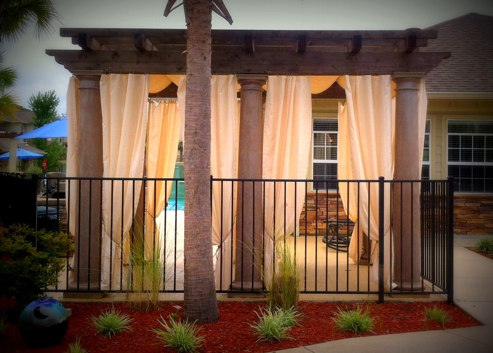 Design ideas for a medium sized coastal patio in Miami with concrete slabs and a pergola.