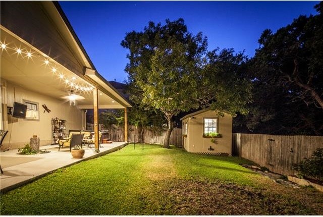 Example of a mid-sized eclectic backyard concrete paver patio design in Austin with a roof extension