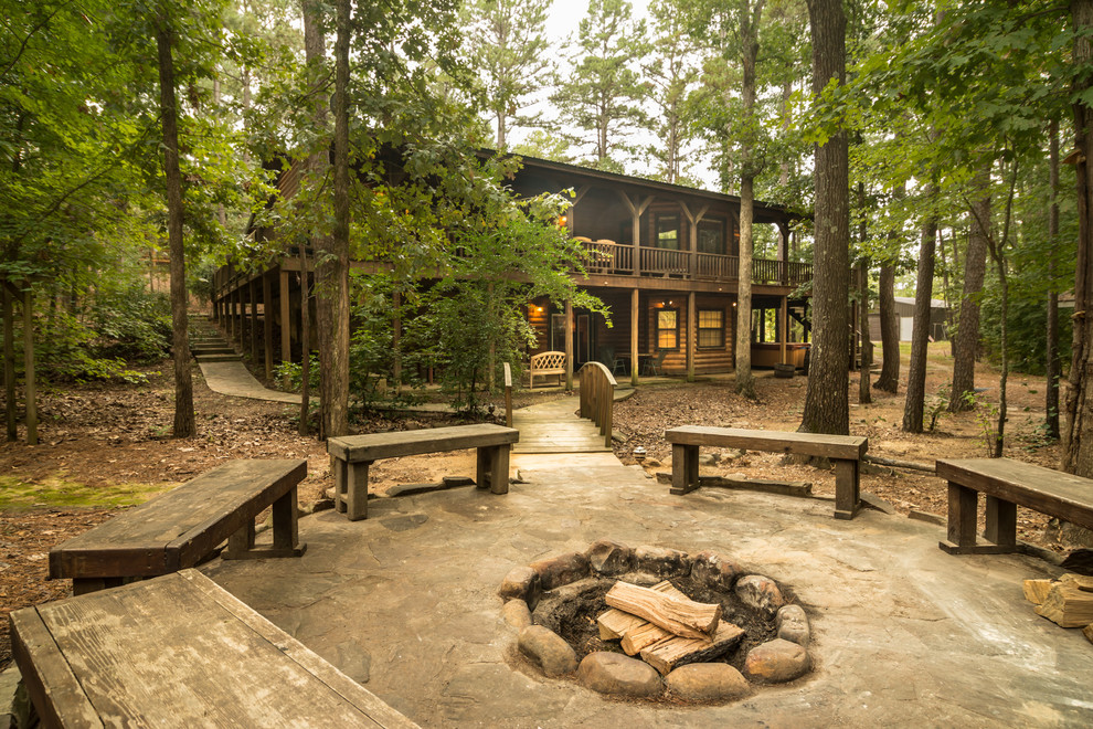 This is an example of a rustic patio in Oklahoma City with a fire feature and no cover.