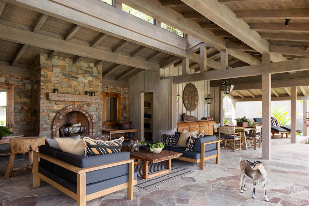 Design ideas for a rural patio in San Diego with a roof extension and a fireplace.