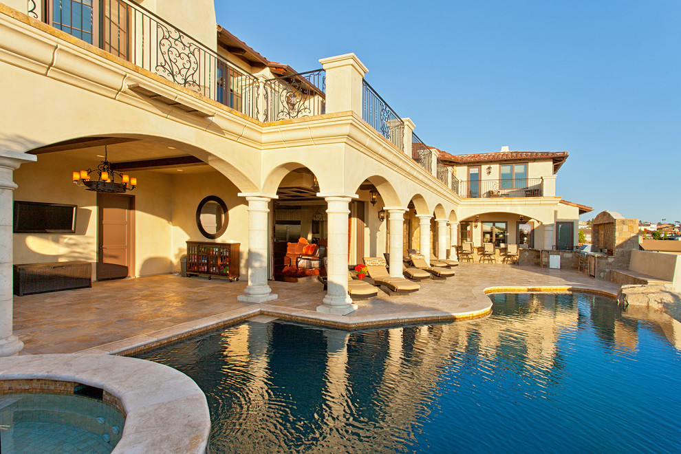 Example of a huge tuscan side yard stone patio fountain design in San Diego