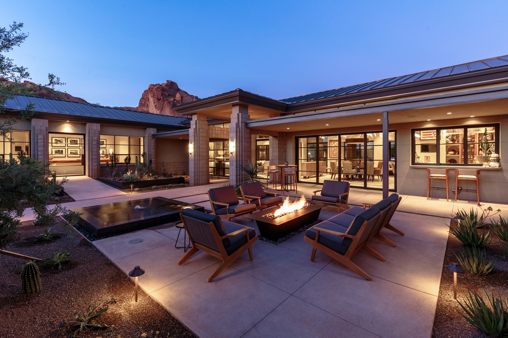 Inspiration for a contemporary courtyard patio in Phoenix with a fire feature.