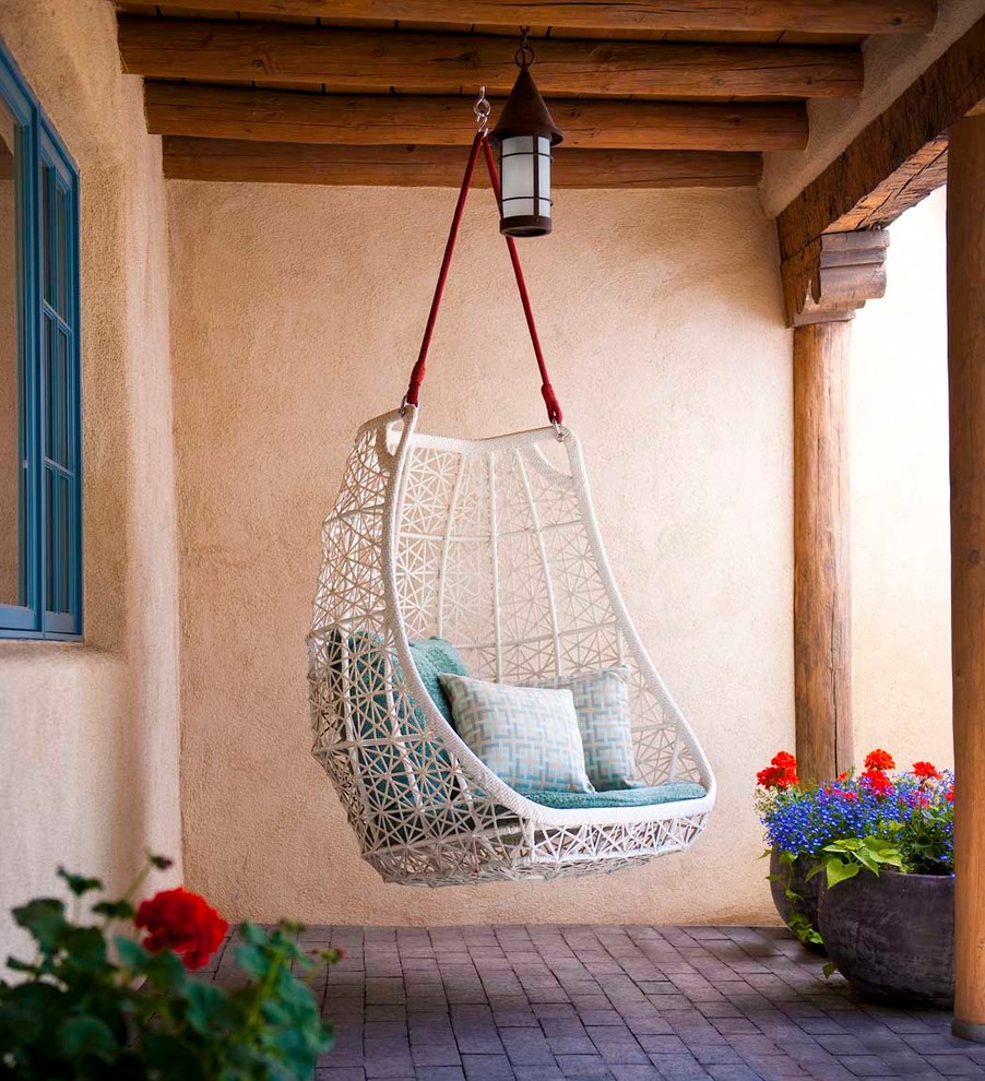 Patio - southwestern patio idea in Albuquerque with a roof extension