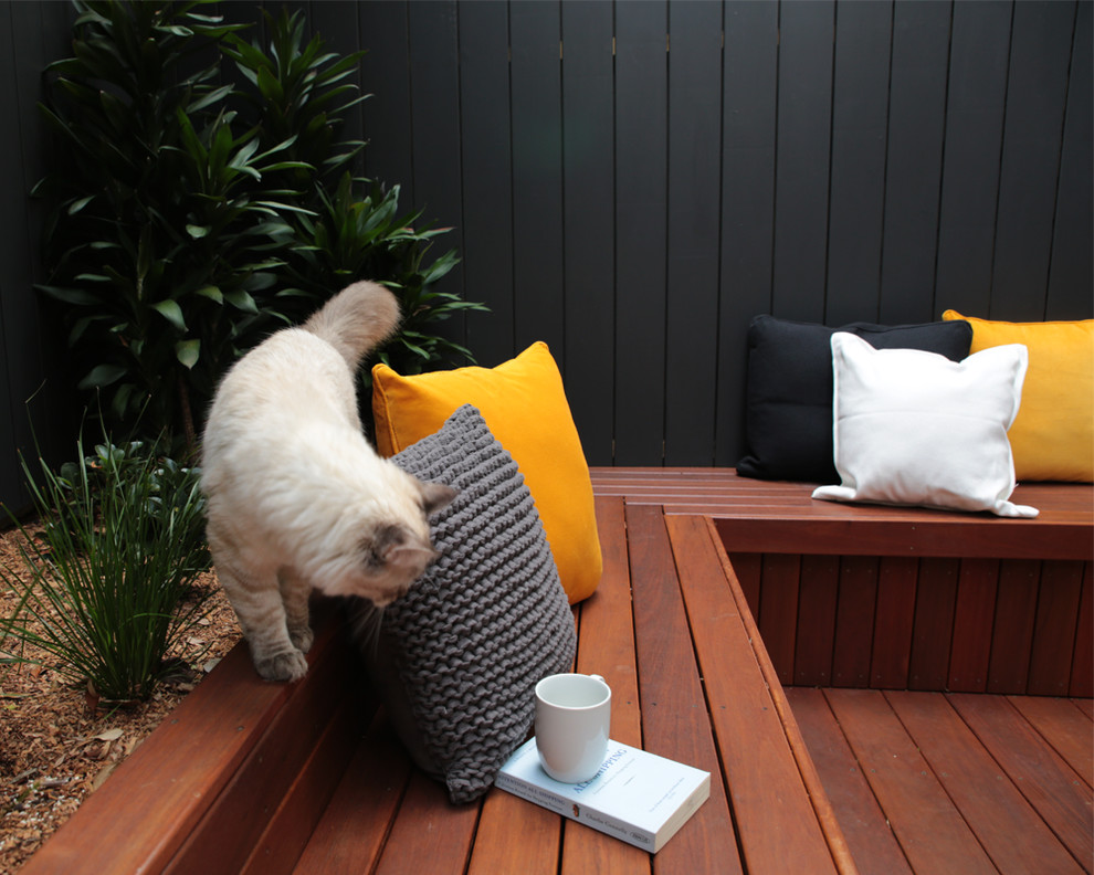 Example of a small trendy courtyard patio kitchen design in Sydney with decking and no cover