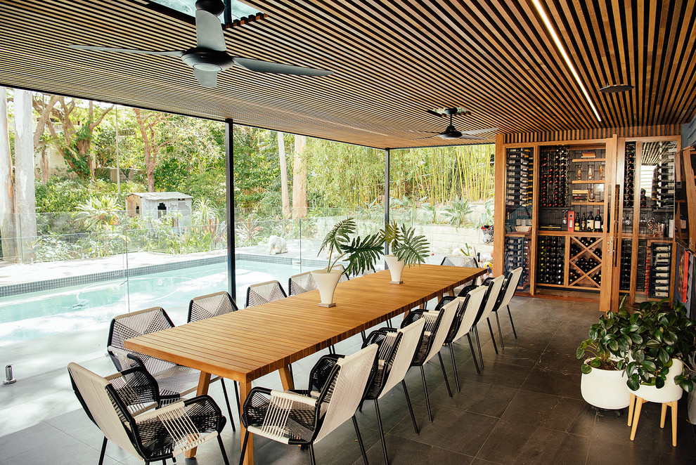 Cette photo montre une terrasse arrière tendance avec une cuisine d'été et une extension de toiture.