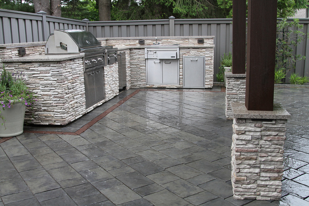 Mid-sized elegant backyard concrete paver patio kitchen photo in Boston with no cover