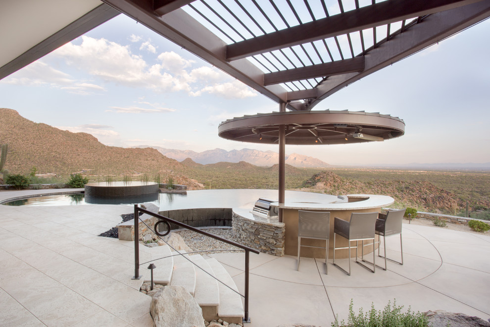 Idées déco pour une grande terrasse arrière contemporaine avec une cuisine d'été, des pavés en brique et une pergola.