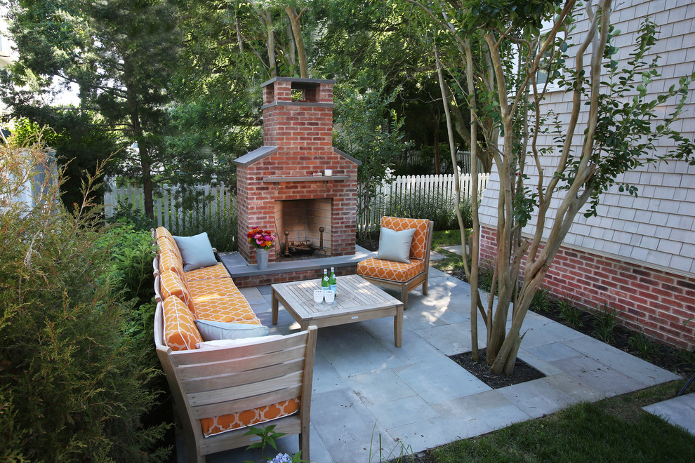 Photo of a large beach style back patio in Philadelphia with a fire feature, concrete paving and no cover.