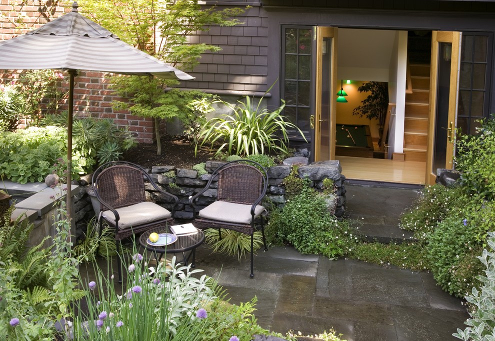Classic patio in Seattle with natural stone paving.