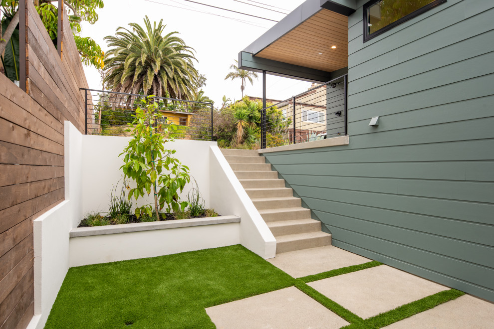 Photo of a medium sized modern courtyard patio in San Diego with a vegetable patch, concrete slabs and no cover.