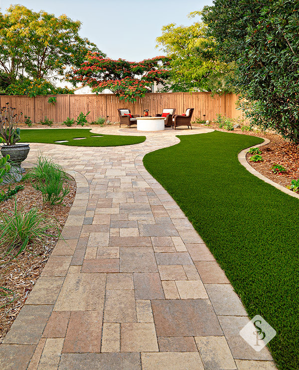 Inspiration for a large backyard concrete paver patio remodel in San Diego with a fire pit
