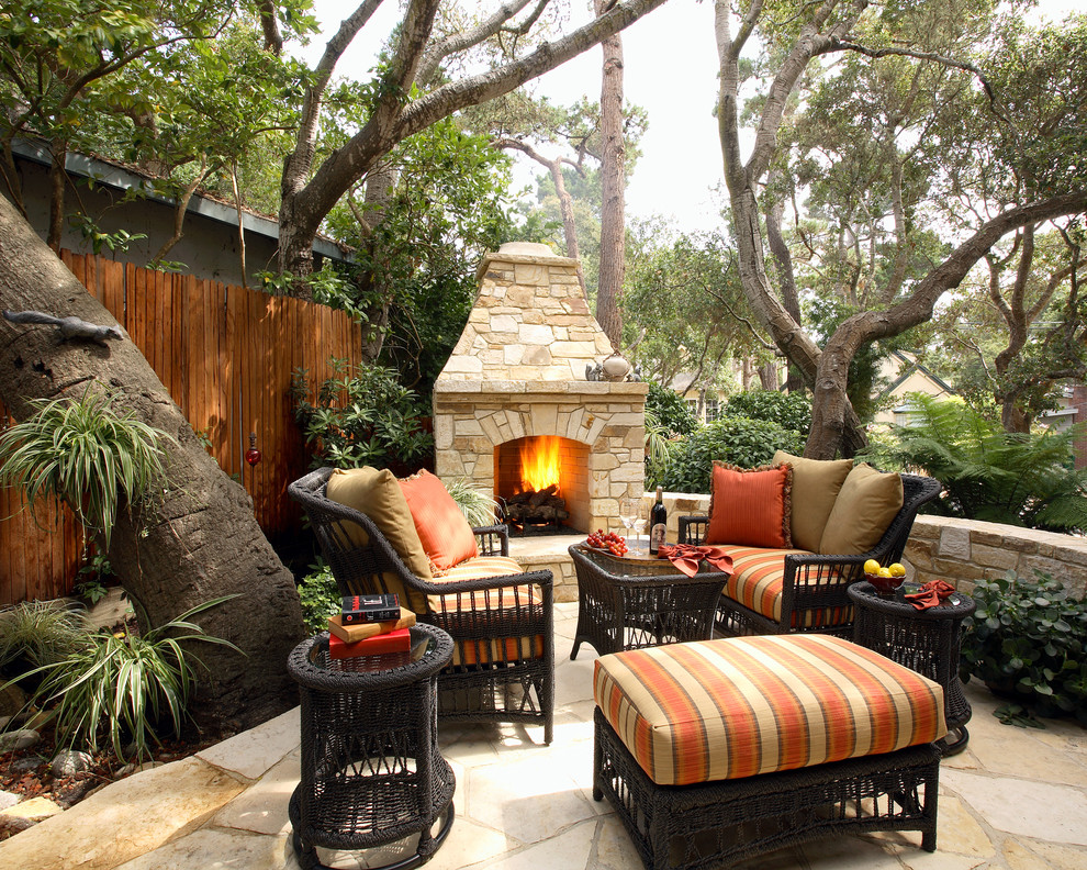 Example of a mid-sized classic backyard stone patio design in San Francisco with a fire pit and no cover