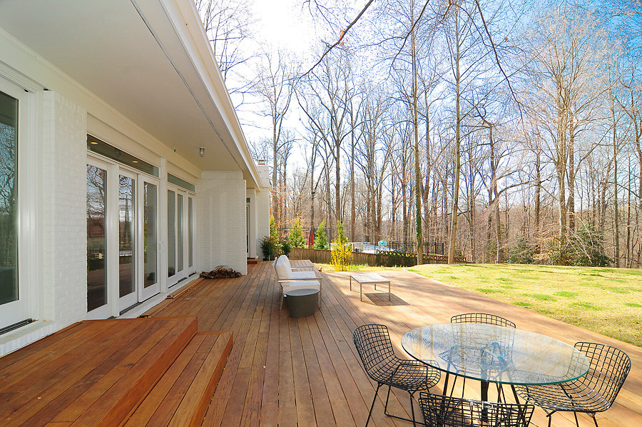 Design ideas for a large contemporary back patio in DC Metro with decking and a roof extension.