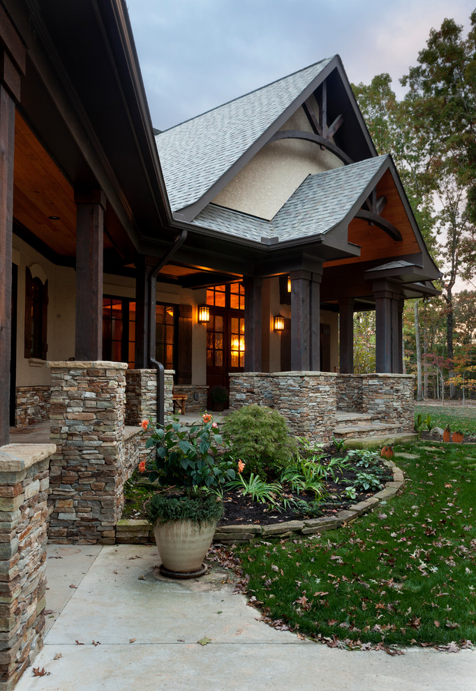 Mid-sized mountain style front yard concrete patio photo in Charlotte with a roof extension