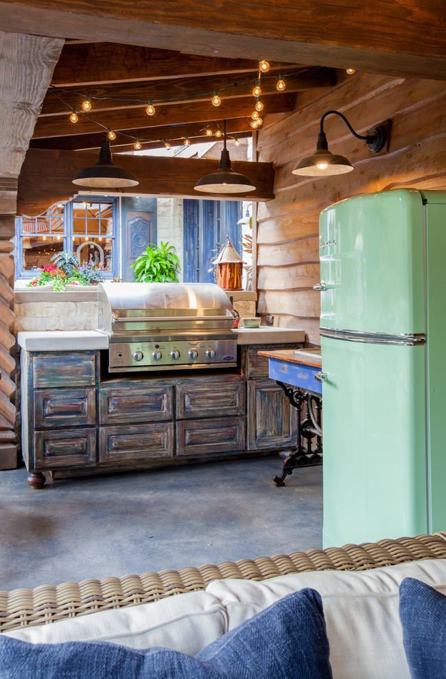 Example of a mountain style patio kitchen design in Dallas with a gazebo