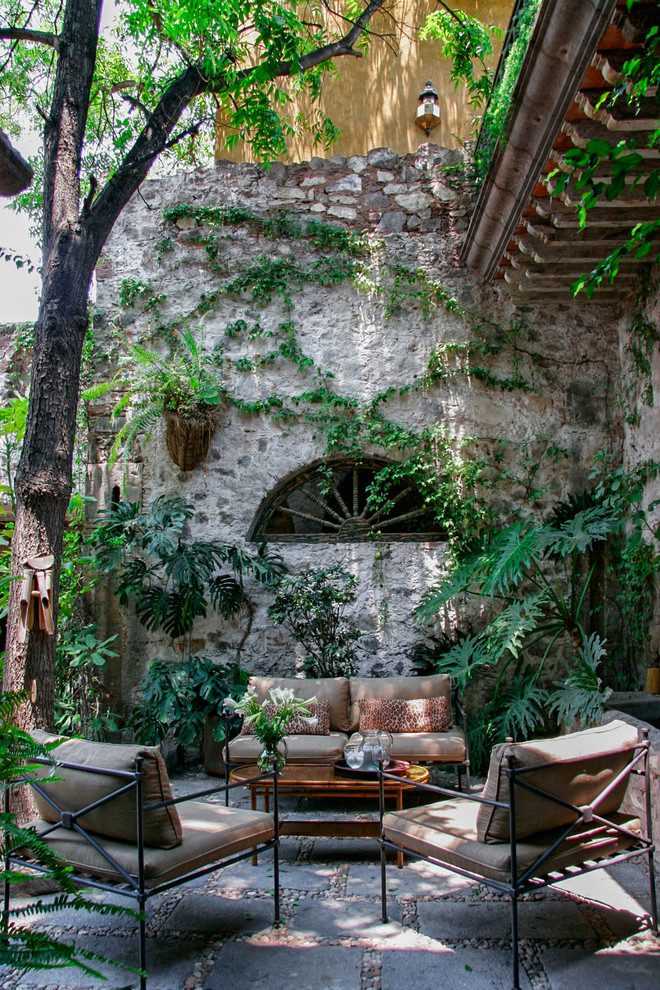Design ideas for a mediterranean patio in Other with a living wall.