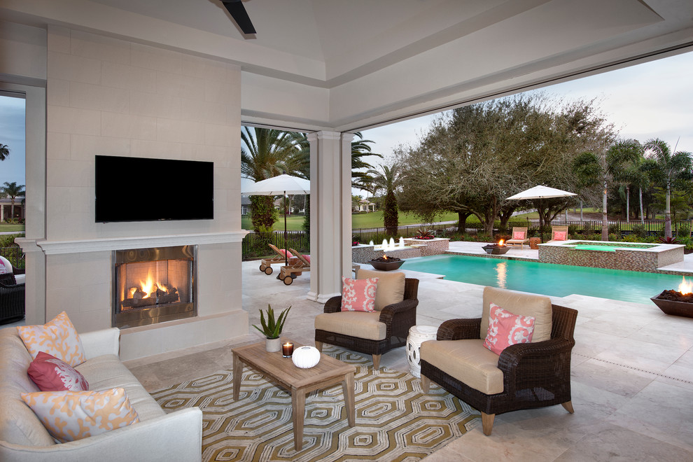 Inspiration for a large contemporary backyard tile patio remodel in Miami with a fire pit and a roof extension