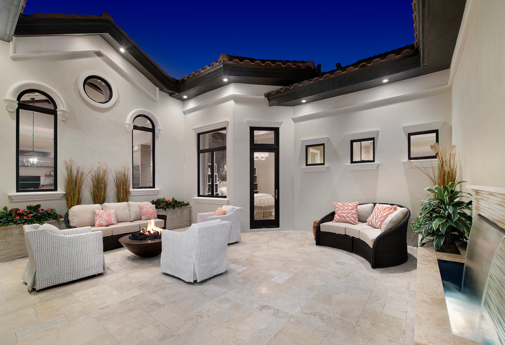 Photo of a large contemporary side patio in Miami with a fire feature, tiled flooring and no cover.