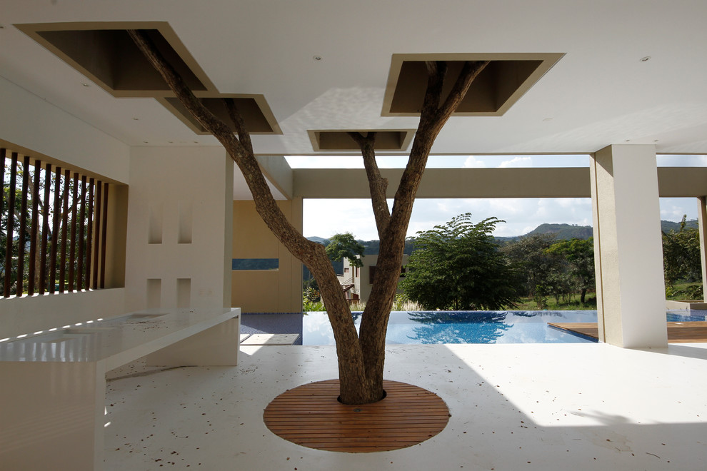 Photo of a modern patio in Other with a roof extension.