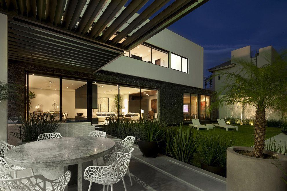 This is an example of a contemporary patio in Other with a pergola.