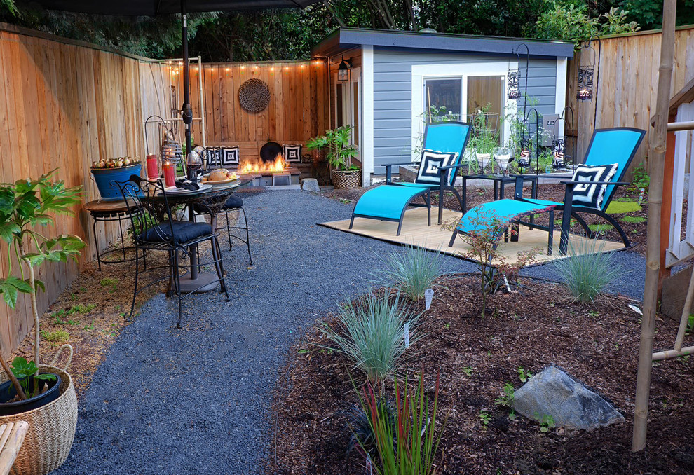 Medium sized traditional back patio in Portland with a fire feature, gravel and no cover.