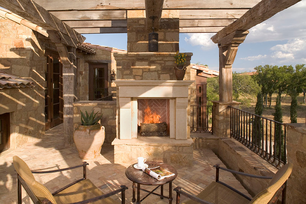 Inspiration for a mediterranean patio in Austin with a fire feature and a pergola.