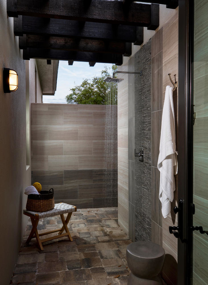 Large transitional side yard outdoor patio shower photo in Other with a pergola