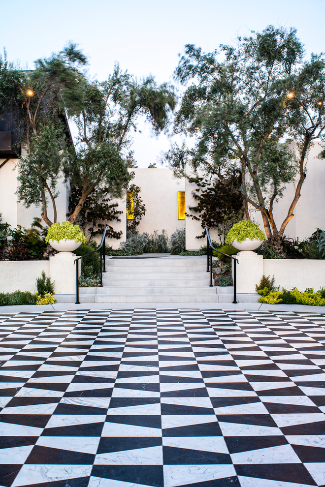 This is an example of an expansive modern courtyard patio in San Francisco with natural stone paving and no cover.