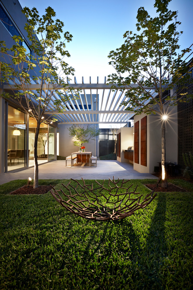 Example of a mid-sized trendy backyard patio design in Melbourne