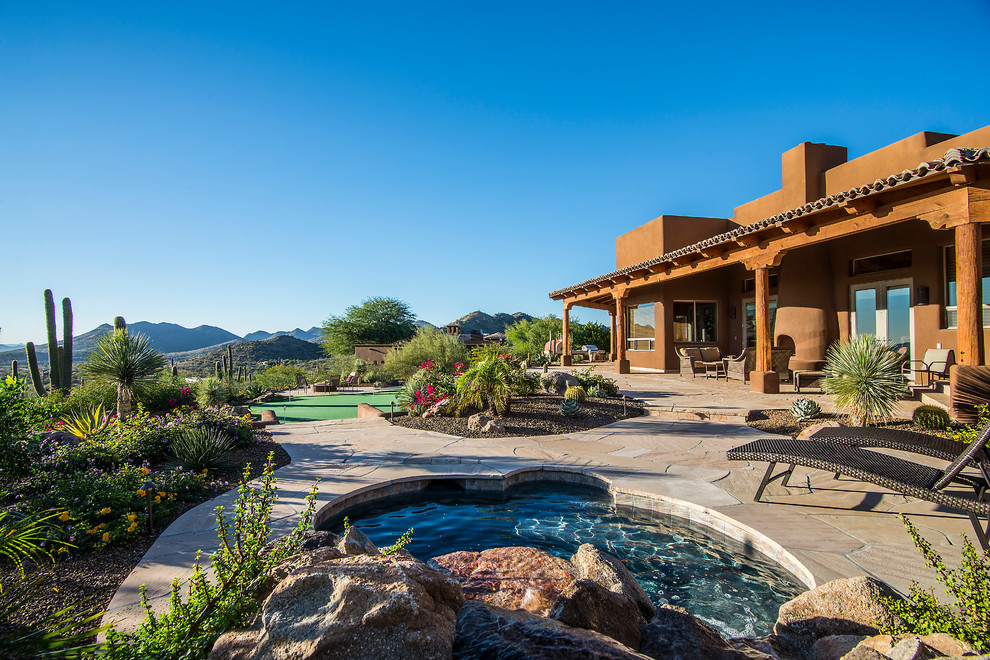 Expansive patio in Phoenix with a water feature and stamped concrete.