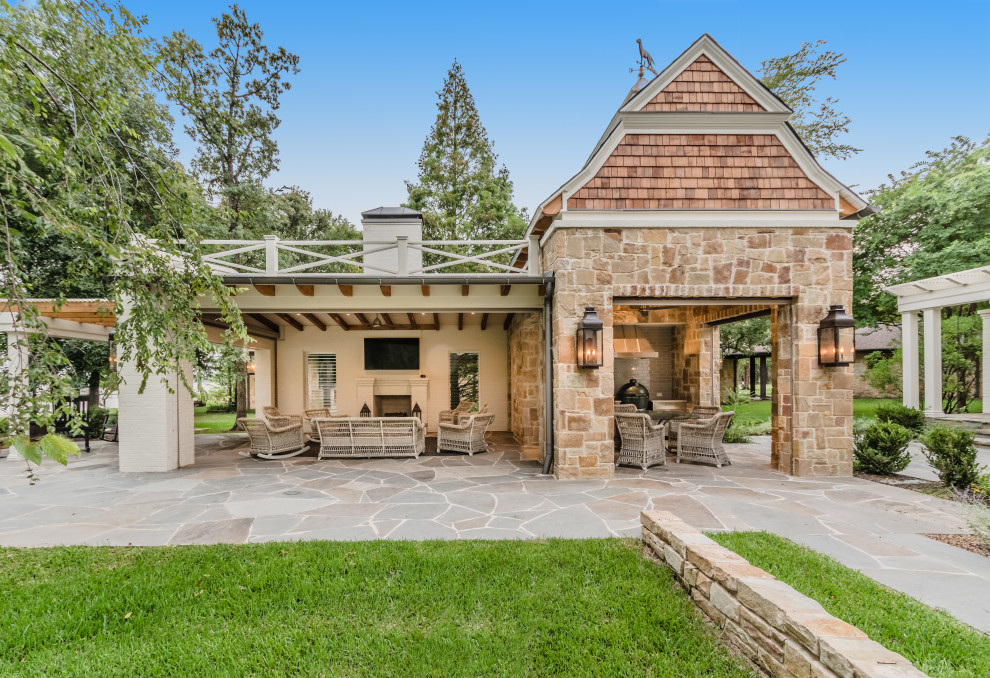 Traditional back patio in Dallas with an outdoor kitchen and a gazebo.