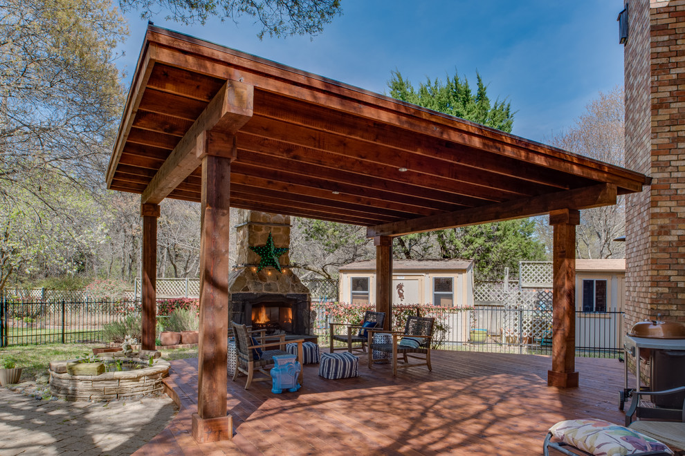 Large traditional back patio in Dallas with a fire feature, decking and a gazebo.