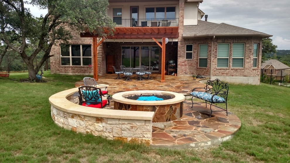 Design ideas for a medium sized back patio in Austin with a fire feature, a pergola and natural stone paving.